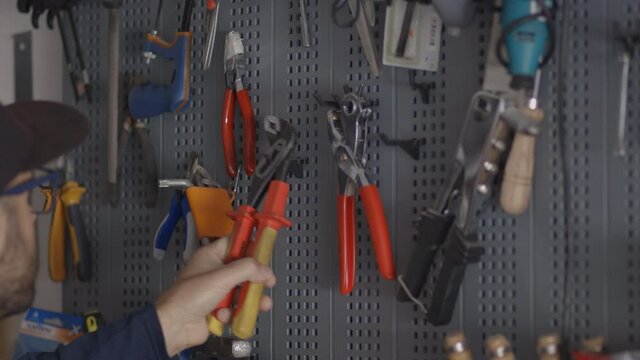 Man chooses a tool from his laboratory, bricolage and "do it yourself" concept