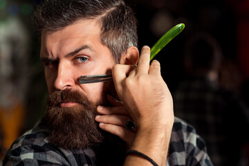 Brutal guy holding proffecional tools. Barber shop. Vintage barbershop, shaving. Vintage straight...