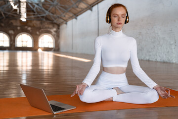 Healthy young woman doing yoga exercises