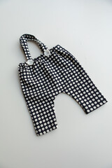 Combed cotton clothes and newborn hats of various colors and types on a white background.