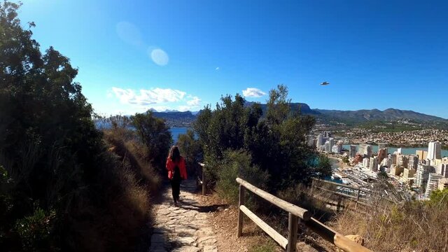Calpe  coast from path above the city in the penon the ifach. Tourists visit Calp and Penyal d'Ifac Natural Park. View of Calp coast from a path above sea level.