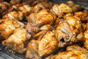 Appetizing grilled chicken with a golden brown crust on the display case.