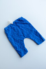 Combed cotton clothes and newborn hats of various colors and types on a white background.