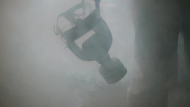 Lonely human in protective gas mask. Protective suit clothes.