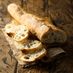 Traditional homemade baguette bread on a wooden desk