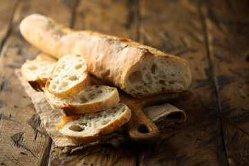 Traditional homemade baguette bread on a wooden desk
