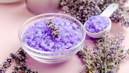Fototapeta na wymiar Lavender violet sea salt with lavender flowers. Lavender bath products Aromatherapy treatment on pink color background. Skincare spa beauty bath cosmetic products for relax.