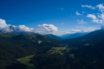 Wonderful springtime landscape in mountains. Grassy field and rolling hills. Sunny afternoon. Rural scenery. Panorama of beautiful countryside of Italy.