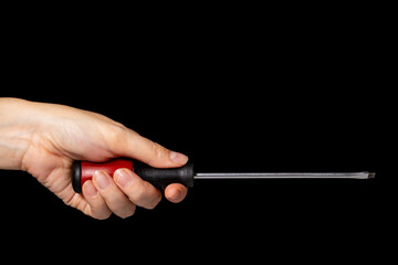 Man hand holding screwdriver on black background, Industrial and business concept, Dark tone.