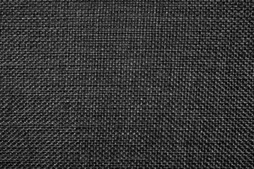 Abstract cloth background in black and white. A seamless texture in a low key. 