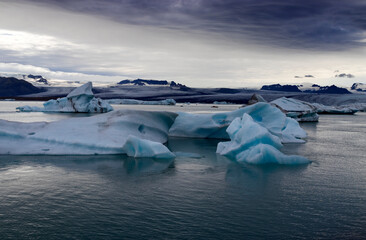 Melting glaciers climate change concept. Dramatic image of icebergs in Jokulsarlon lagoon at the evening. South Iceland. © Sonyara