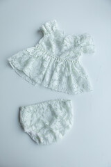 Combed cotton clothes and newborn hats of various colors and types on a white background.