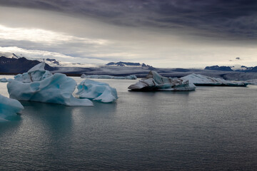 Melting glaciers climate change concept. Dramatic image of icebergs in Jokulsarlon lagoon at the evening. South Iceland.