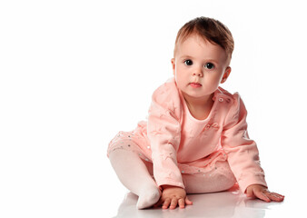Cute baby girl sitting isolated on white background