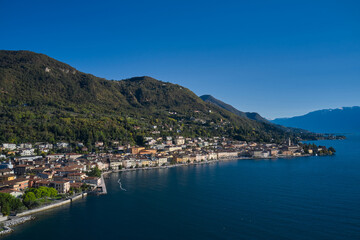 Fototapeta na wymiar Panoramic view of the historic part of Salò on Lake Garda Italy. Aerial view of the town on Lake Garda. Tourist site on Lake Garda. Lake in the mountains of Italy.