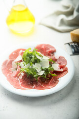 Traditional beef carpaccio with arugula
