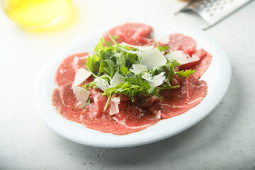 Traditional beef carpaccio with arugula