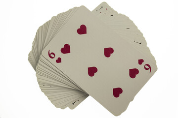 Curved deck of playing cards. Above is a red six. Photographed on a clean white background with clipping