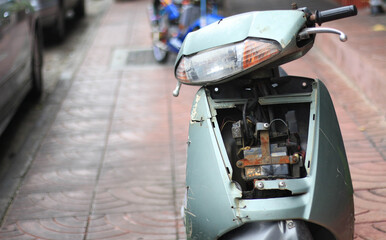 Motorcycle has been broken parked on roadside.