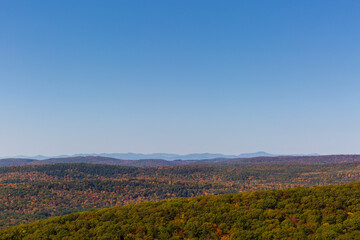 Colorful Autumn vistas of mountains and valleys. Yellow, orange and red leaves glisten in the sunshine- 5