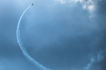 blue plane flying against a blue sky