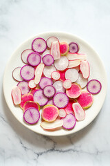 Fresh radishes on a white plate