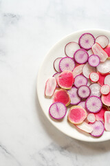 Fototapeta na wymiar Fresh radishes on a white plate