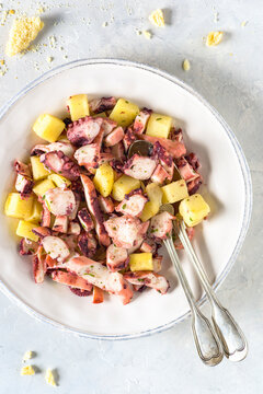 Fresh and healthy octopus salad with potatoes.  Traditional dish from Italian. Top view.