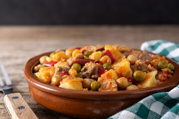 Ropa vieja food in bowl on rustic wooden table	