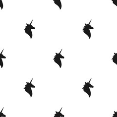 seamless fantasy pattern with black silhouette of unicorns head.