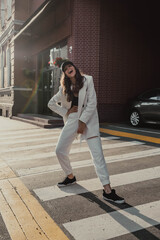 Full Length Portrait of Trendy Stylish Girl Wearing a Fashion White Suit on Urban Background