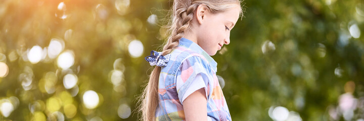 Beautiful american portrait of schoolgirl. Preschool kid. Little happy girl outdoors. Pretty female...