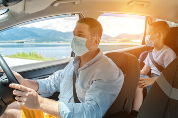Father and son in protective masks driving car, Happy traveler family. Bonding Travel, Summer, Holidays, Journey, Trip concept.