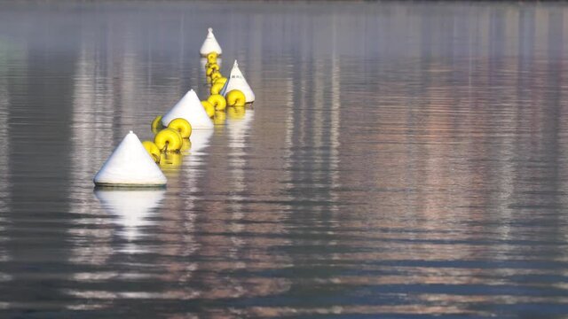 white and yellow buoys connected with a rope indicate the swimming area