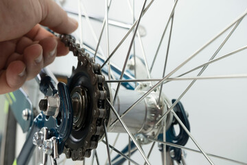 Fototapeta na wymiar close up portrait person's hand repairing wheel on the bicyle