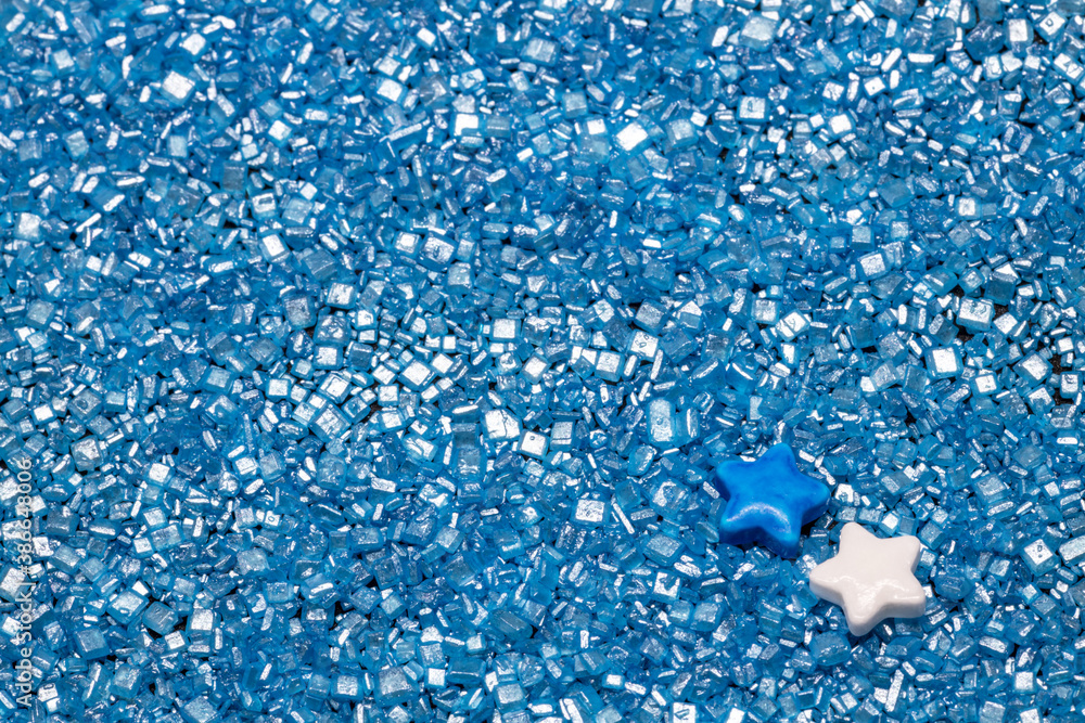 Wall mural white and blue cake decoration stars on blue sugar glitter