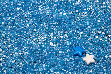 white and blue cake decoration stars on blue sugar glitter