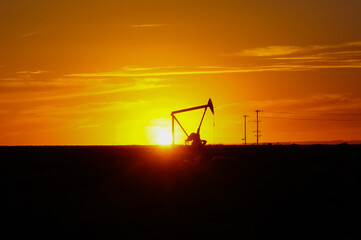 Silhouette Oil pumps at oil field with sunset sky background