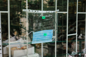 samples of medical masks with price are located in the pharmacy window