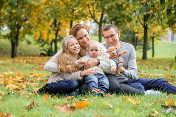 Naklejka na ściany i meble happy family on autumn picnic in park