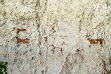 Wall paintings depicting hunters & deer. Located inside one of caves of ancient city-fortress Chufut Kale, Bakhchysaray, Crimea. Author is unknown (possibly primitive people)