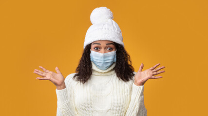 Portrait of black woman in medical mask showing clean hands