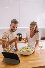 Vlogger and blogger freelance job concept, Young  couple cooking together and recording live video for her vlog and social media 