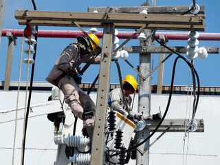 electrician man working at height and dangerous ,high voltage power line maintenance