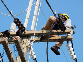 electrician man working at height and dangerous ,high voltage power line maintenance