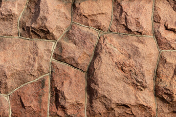 The surface of the masonry is made of roughly hewn large red stones, fitted together.