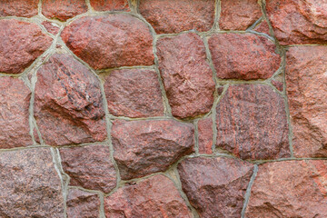 The surface of the masonry is made of roughly hewn large red stones, fitted together.