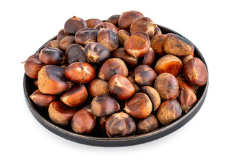 Roasted chestnuts on a round plate  isolated on white background. Healthy nuts closeup.