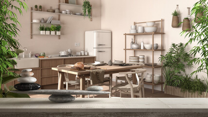Wooden vintage table or shelf with gray pebble balance and bamboo green plants over country rustic wooden kitchen