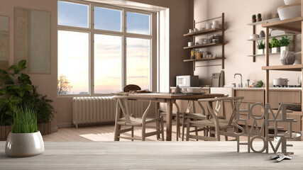 Wooden table, desk or shelf with potted grass plant, house keys and 3D letters home sweet home, over kitchen with dining table, architecture interior design, copy space background